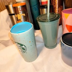 A baker's dozen Starbucks mugs and tumblers.